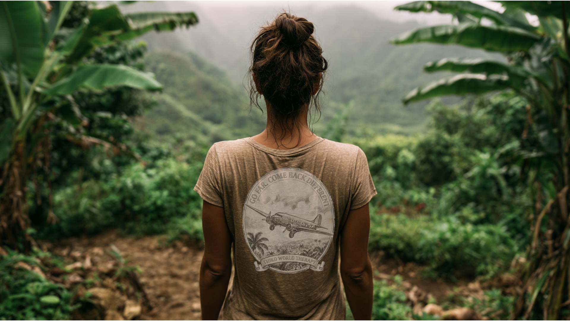 A traveler on a jungle trail wearing the Go Far Come Back Different tee - Third World Therapy